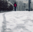 low-angle-shot-of-a-person-walking-on-the-snow-covered-sidewalk-under-the-snow_181624-21806.jpg - ГТРК Владимир